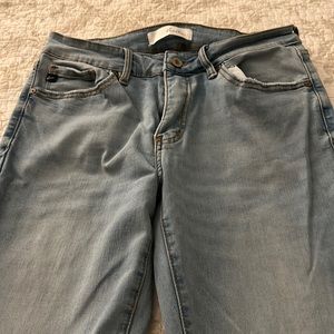 Kancan mid rise stretch jeans with raw hem.